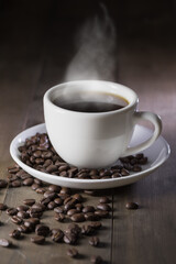 hot coffee with smoke on brown wood