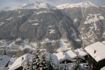 Morning view of Awakening Swiss valley, chalets, snow and cold fresh landscapes