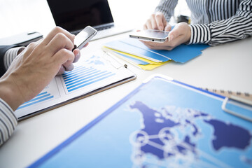 Men and women have meetings while holding smartphones, respectively