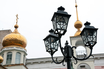 Fototapeta na wymiar Vintage lanterns on background of domes of church