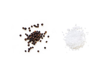 Dried whole seed of black pepper and white coarse sea salt isolated on a white background seen from...