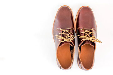Men's classic brown leather shoes isolated on white background, Top view with copy space and text.
