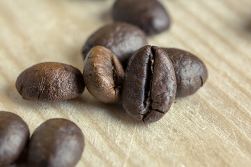 close up coffee beans on wooden background with effect filter.