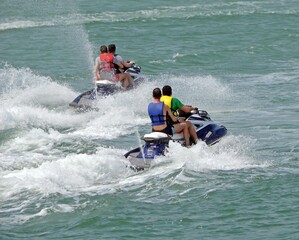 Jet ski riders running waves on the florida intra-coastal waterway off Miami Beach.
