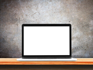 Front view of the laptop is on the work table, concrete grunge wall background.