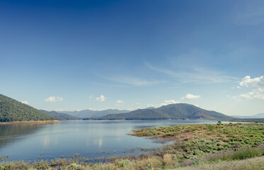 Fototapeta na wymiar Lake with mountain and blue sky background