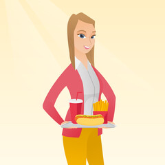 Woman holding tray full of fast food.
