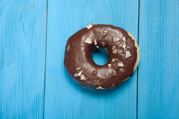 Doughnut on blue wooden table