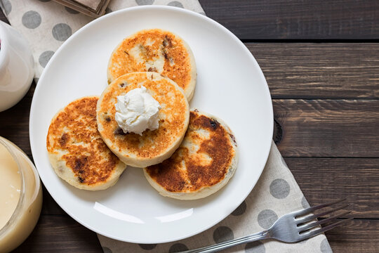 Cheesecakes for breakfast on a dark wooden background