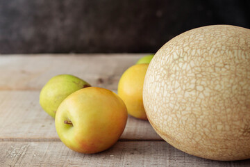 Apples on wooden floor.