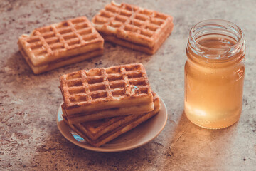 Baked waffles and organic sweet honey for breakfast