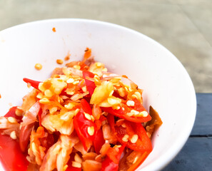 Red Chili crushed and chooped in a white bowl