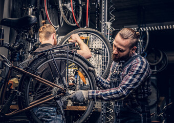 Mechanic fixing rear derailleur from a bicycle.