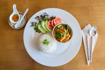 Thai Chicken Curry with Vegetables on wood background