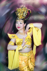asian dancer actress in a yellow traditional chinese stage costume against blurred spot background