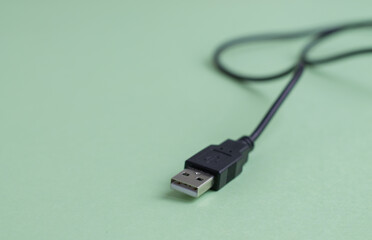 Fototapeta premium Wire with usb connector close-up on a light green background