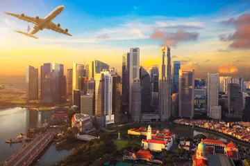 Tuinposter Travel, Transportation concept - Airplane flying over Singapore city in morning time © krunja