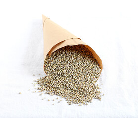 Healthy food pearl millet in a brown paper cone.