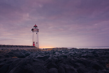 Fototapeta na wymiar Port fairy lighthouse at sunrise with rocks