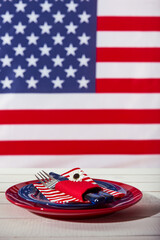 Beautiful blue red and white table setting in front of american flag