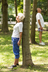 Seniors relaxing beside trees