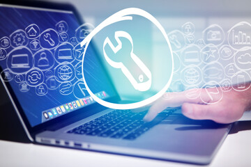 Tool icon going out a laptop interface - technology concept