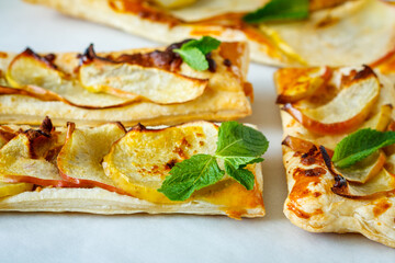 Ruddy puffs with apple, mint and cinnamon. Baking with an apple.
