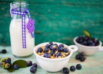 Oatmeal with fresh blueberry fruit on wooden background.