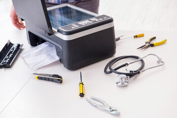 Repairman repairing broken color printer