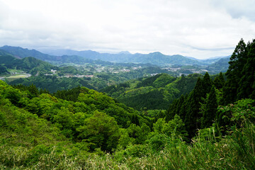 Fototapeta na wymiar Greenery mountain panorama and town view from afar