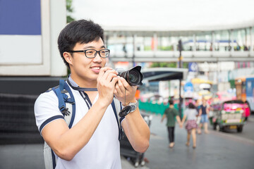 young asian travel with backpack and camera travel in Bangkok ci