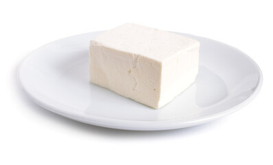 Part of Bryndza on the white plate. Isolated