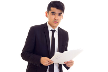 Young man in suit holding papers