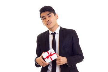 Young man in suit holding a present