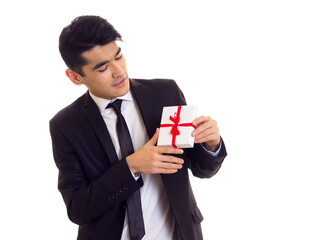 Young man in suit holding a present