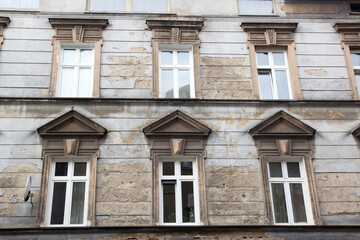 Facade of the old shabby house with a satellite dish