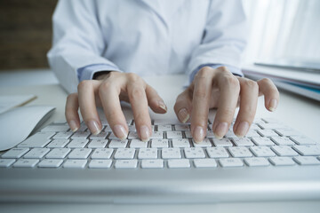 Female doctor typing keyboard