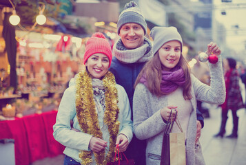 Family of three posing at Christmas market