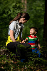 Fototapeta premium mother and son playing in the forest