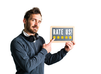 A young man holds a chalkboard saying "Rate us!"