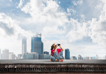Naklejka premium Concept of careless happy childhood with girl of school age looking in future