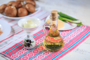 Obraz na płótnie Canvas Olive oil in a glass bottle and capacity for spice