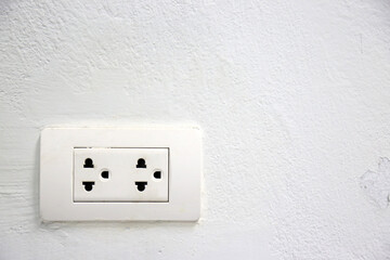 Outlet socket white color on white wall