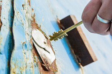 Close-up of opening old rusty metal door
