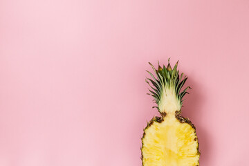 Half slice of beautiful fresh appetizing tasty pineapple on pink background. Top View. Horizontal....