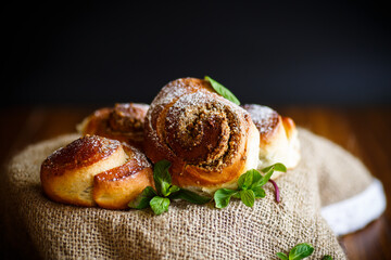 Sweet bun with nut filling in powdered sugar