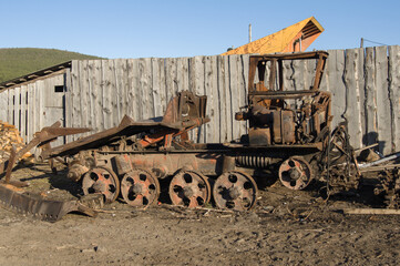 Fototapeta na wymiar Old broken tractor is standing in the village