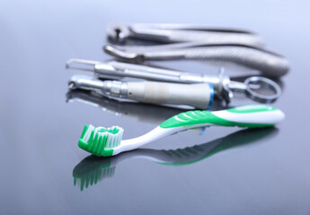 dental care toothbrush with dentist tools on mirror background.