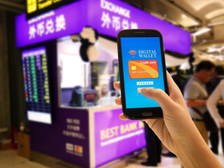 Ecommerce , smart pay, business and technology concept.Digital wallet application on mobile phone to pay for goods and services convenient and fast with blur booth money currency exchange background.