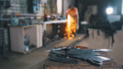 De-focused workshop - grinding iron knifes with sparkles